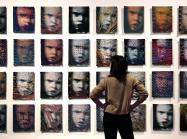 A wall of 32 woven portraits 