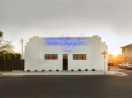 building facade of compound. Features blue artwork by Tavares Strachan